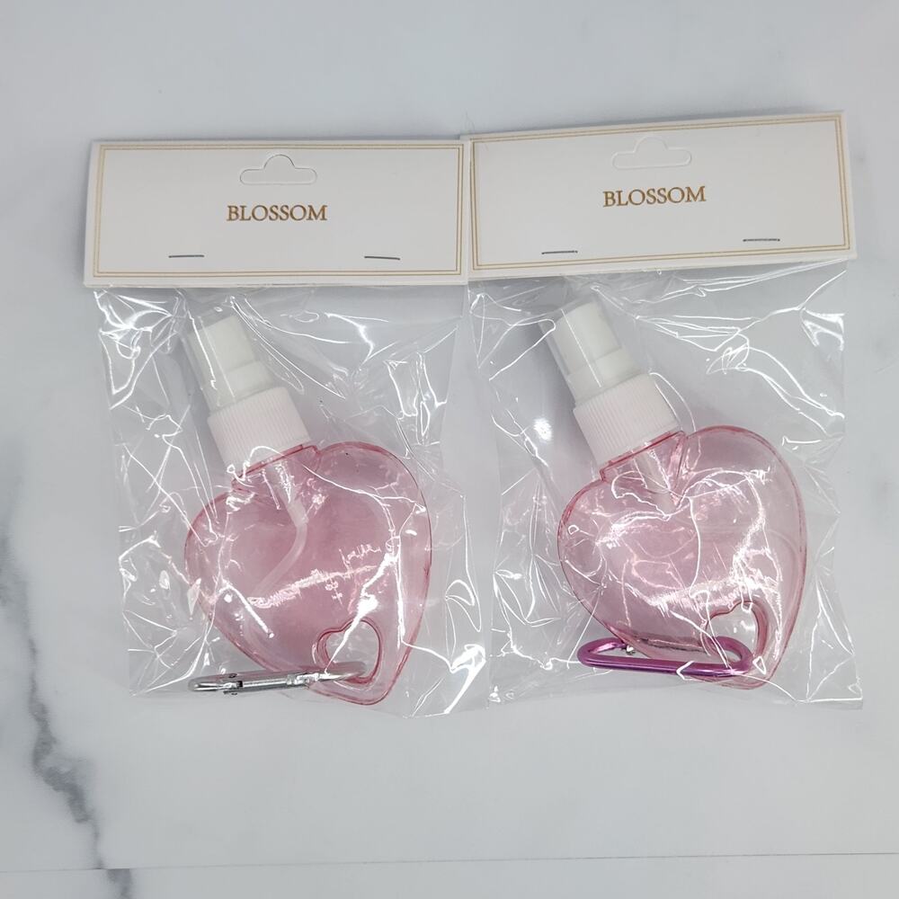 2 Heart Shaped Translucent Spray Bottles with a Carabiner - light pink